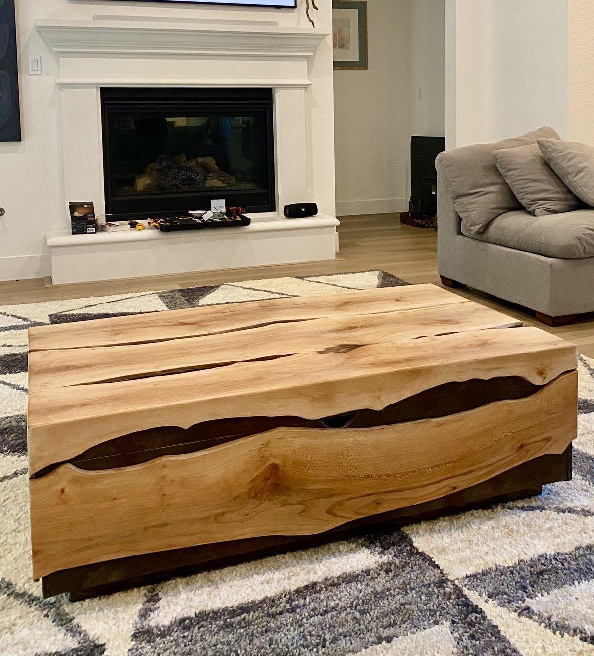 Live edge sycamore slab wrapping a steel frame coffee table