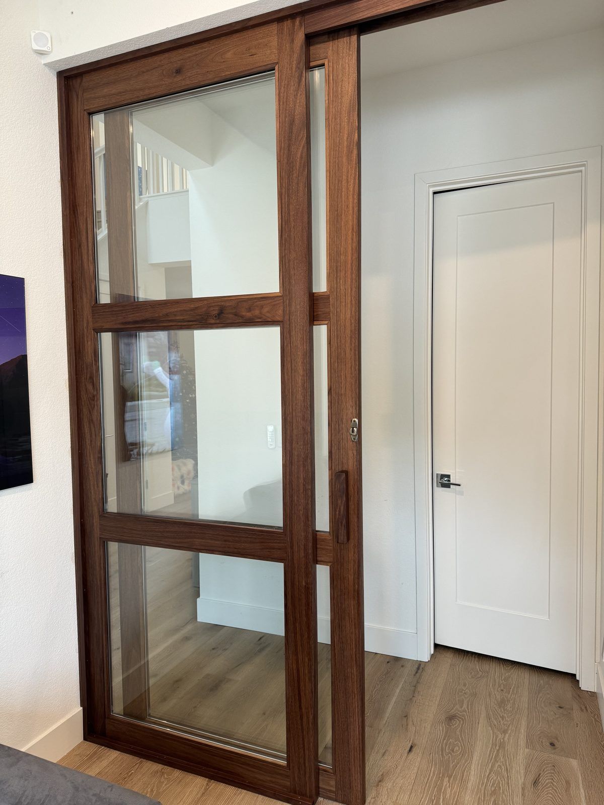 Custom walnut and glass interior sliding door built by Trumanmade