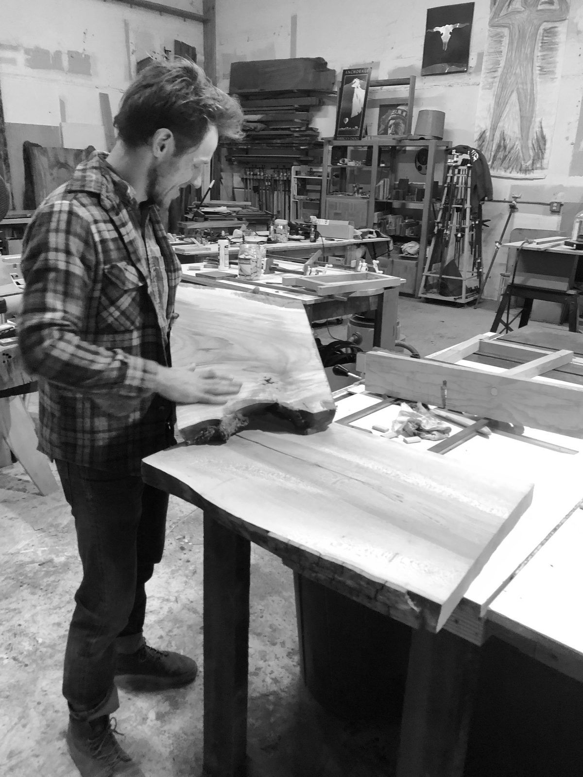 Thomas Truman reading a live edge slab in the Trumanmade workshop in Santa Cruz